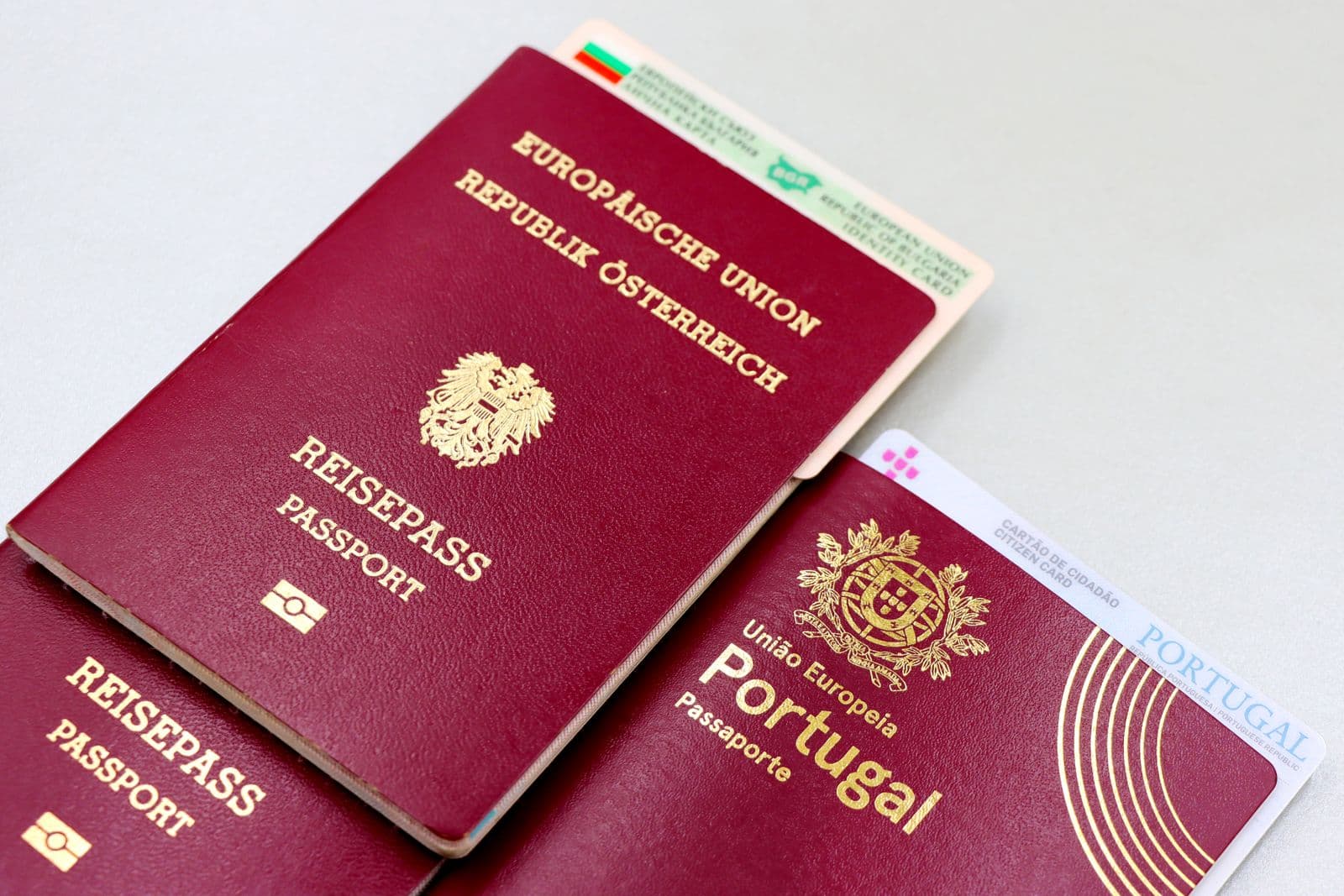 Close-up of European Union passports from Austria and Portugal.
