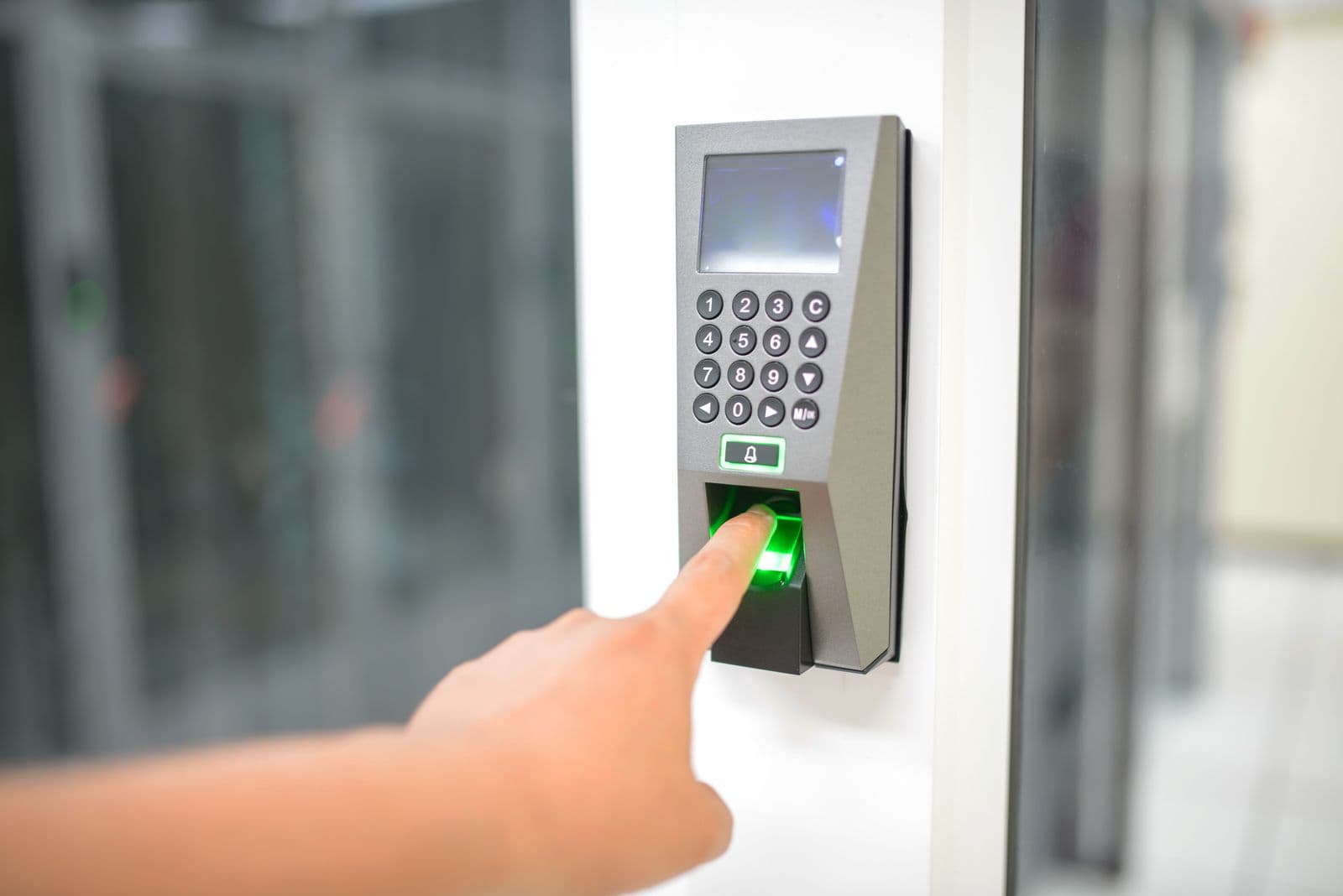 A finger scanning a fingerprint reader for secure identity verification.