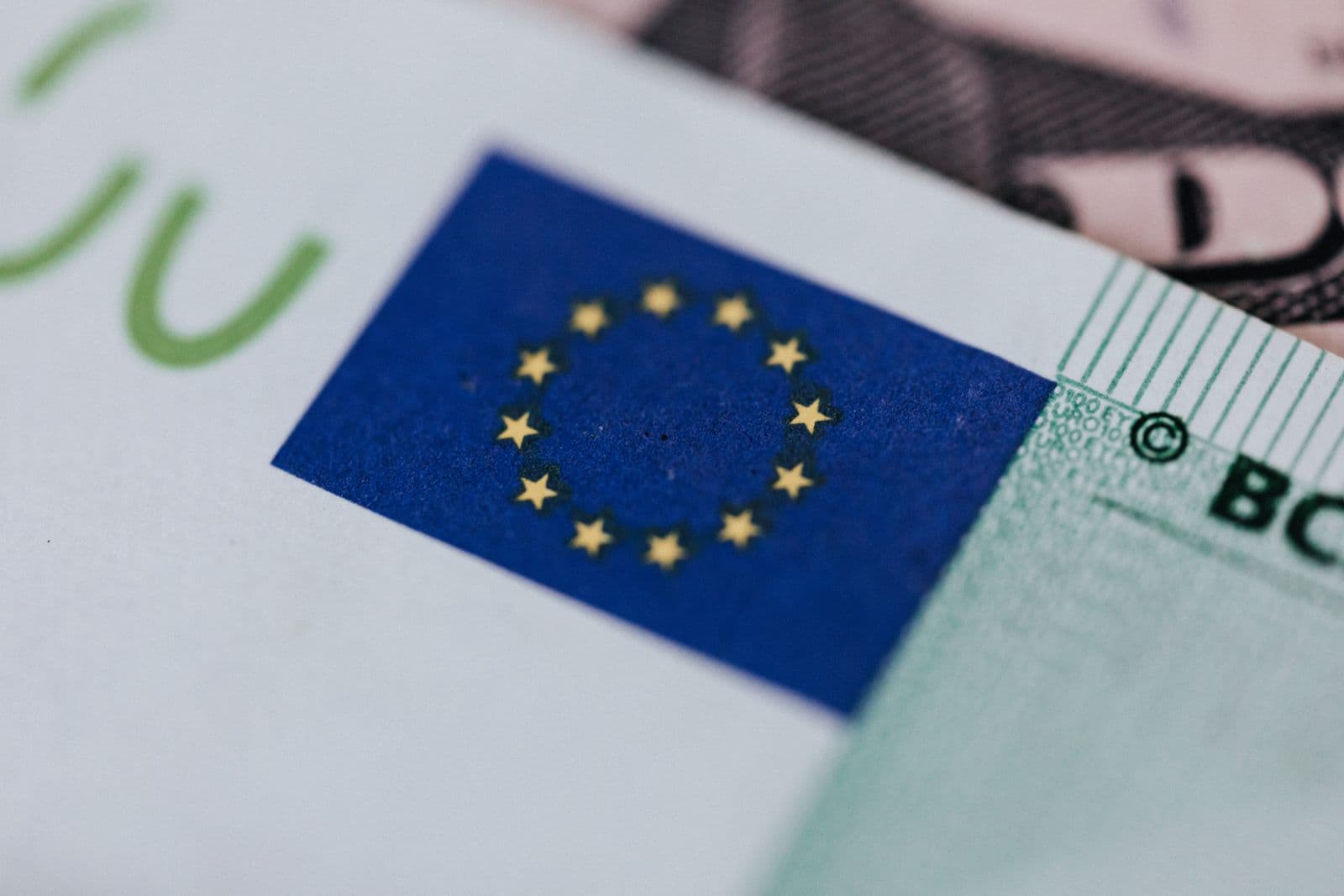 Close-up of the European Union flag printed on a Euro banknote.
